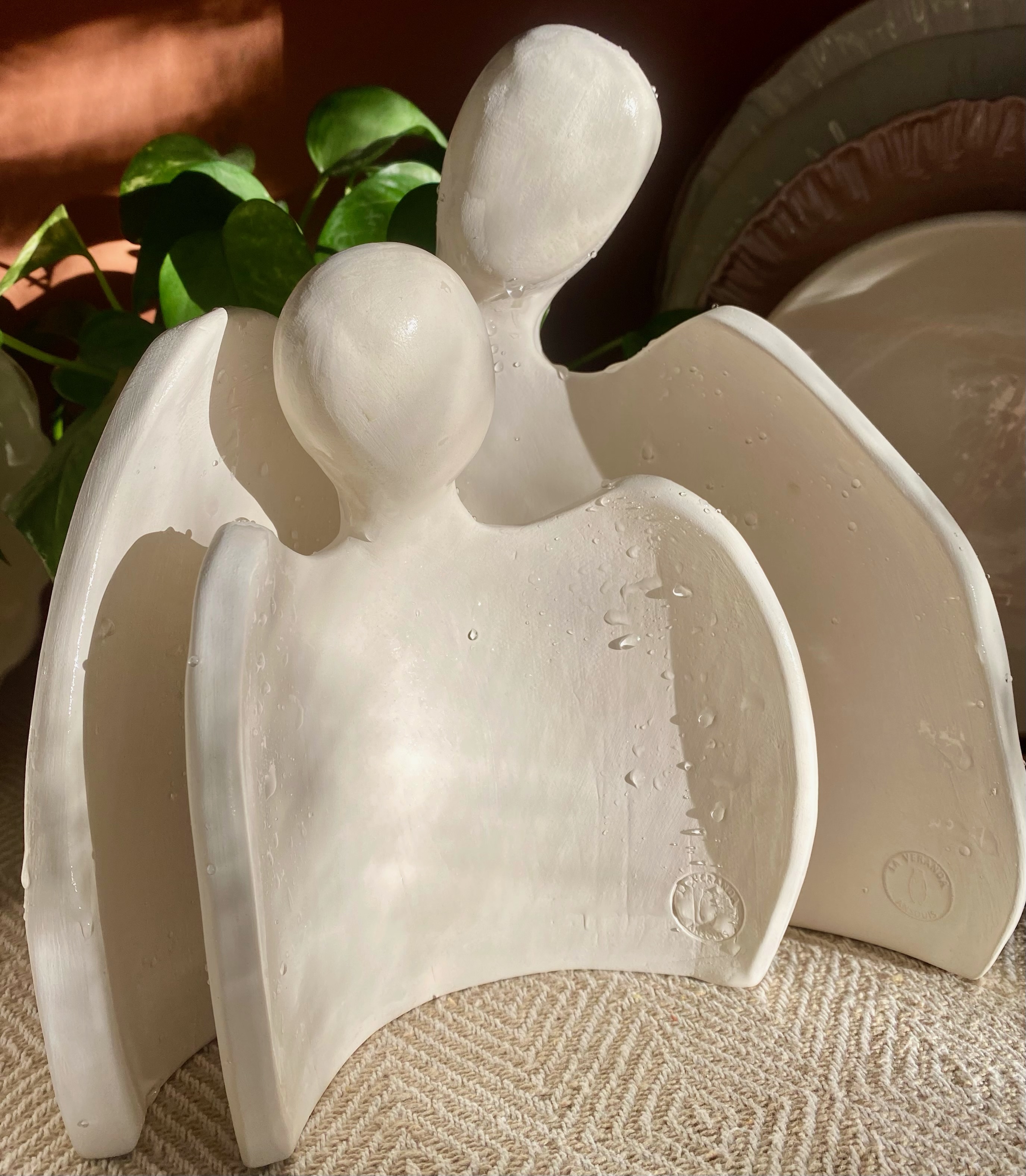 Sculpture céramique deux personnages enlacés aux ailes déployées, art contemporain La Véranda